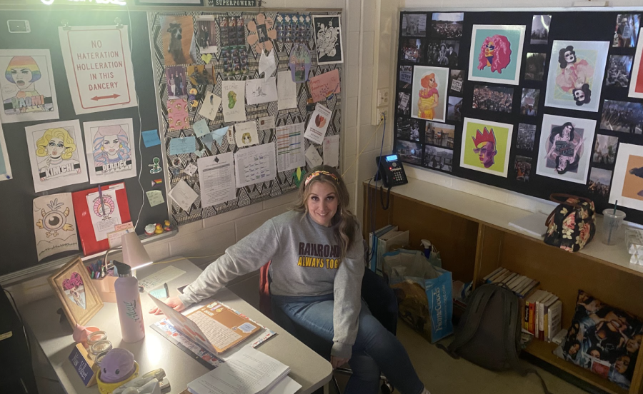 Brunswick teacher, Ms. Volkert, sitting in her classroom that is decorated with inclusive posters and quotes.