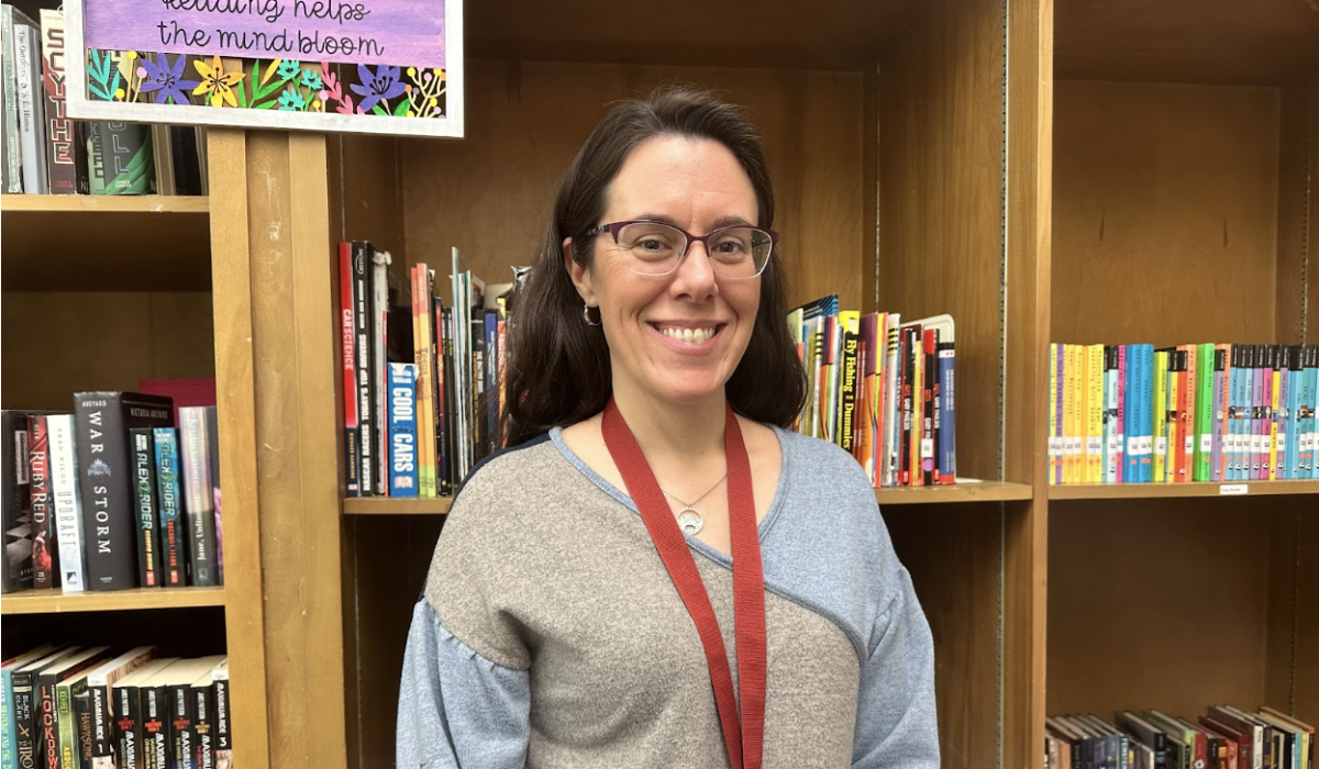 Photo of Mrs. Kowalski taken in her office, which is located in the library!