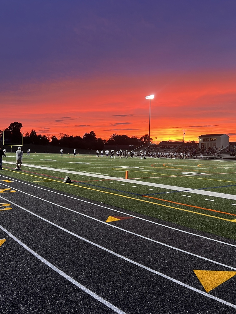 The football team enjoys the sunset at the beginning of the season.  