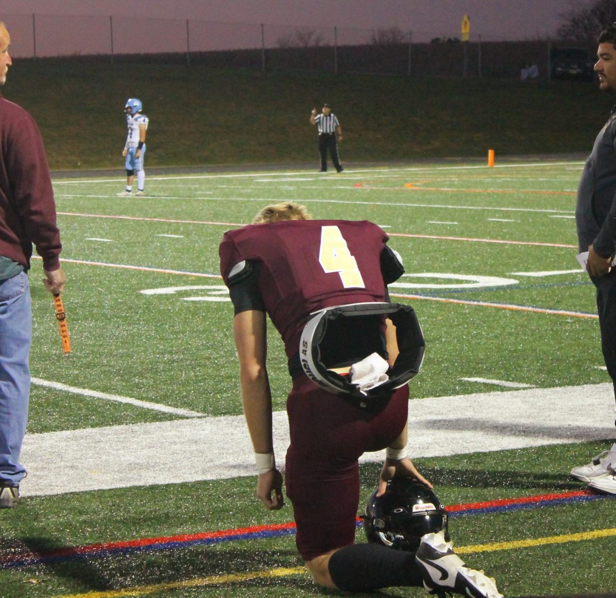 Ethan Houck kneels during the game.