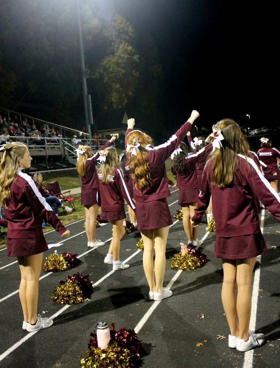 The Cheerleaders watch the game.