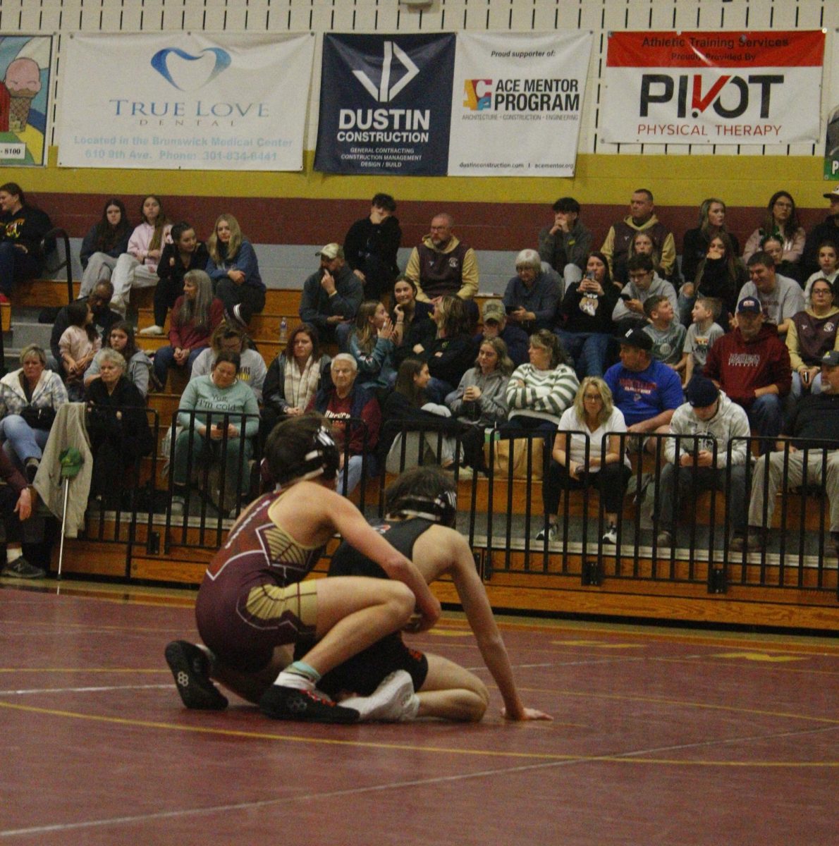 Carter Mullen wraps his arms around his opponent.