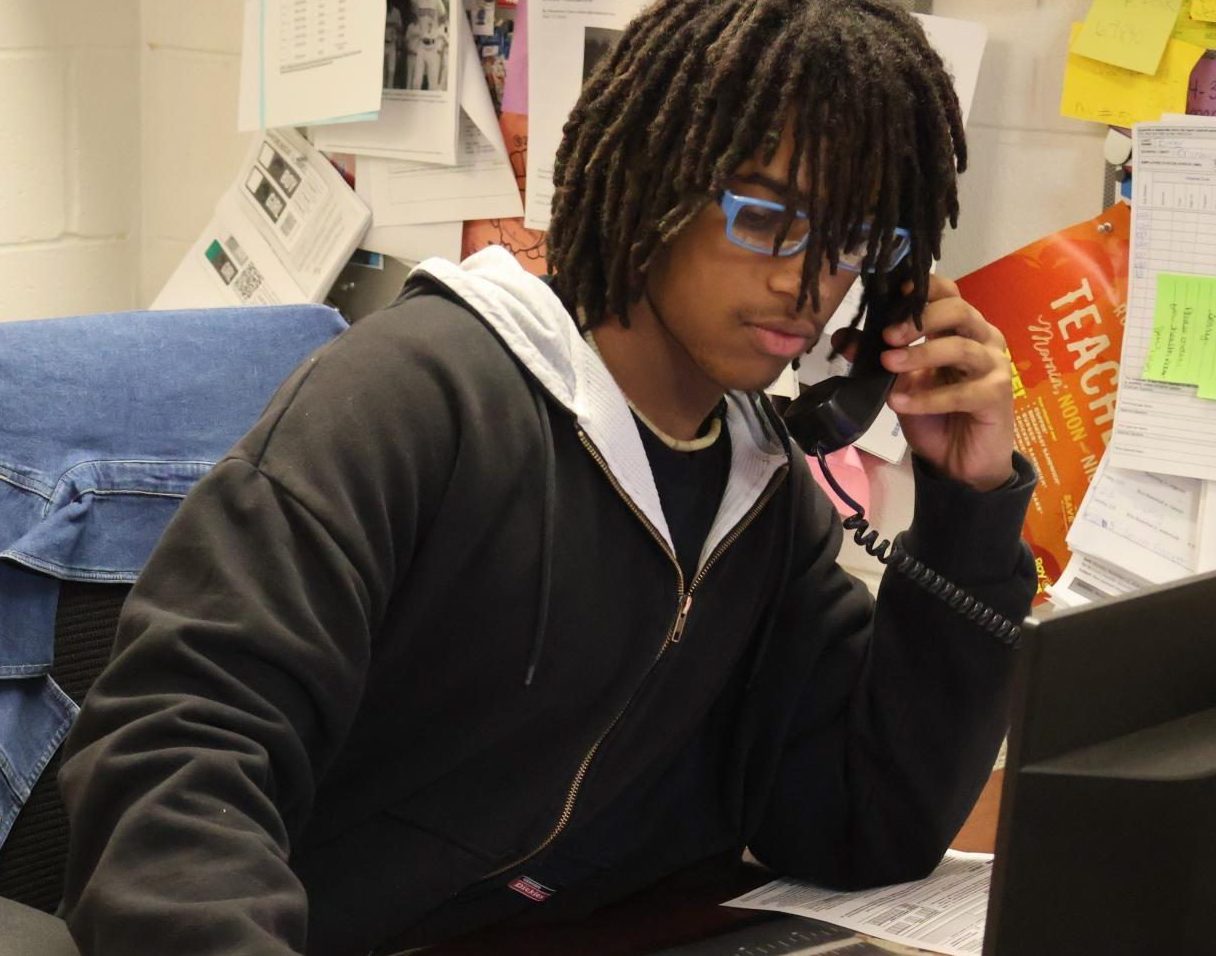 Andre Phillips, a junior, uses Mr. Gardner's desk to work on promotion for the newspaper.