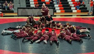 2025 Brunswick Wrestling team meets around the mat.
