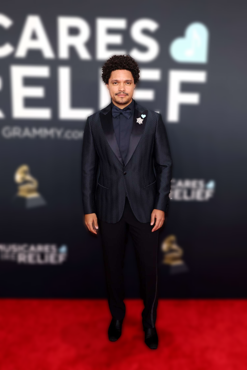 Trevor Noah in Giorgio Armani. Noah had the honors of hosting the 67th Annual Grammy Awards for the fifth time. He is best known for his comedic career as he hosted “The Daily Show” and many other awards shows, along with publishing a book about his early childhood life living in South Africa. He was also nominated for Best Comedy Album but did not win. Adapted in Magic Studios by Caroline Teague