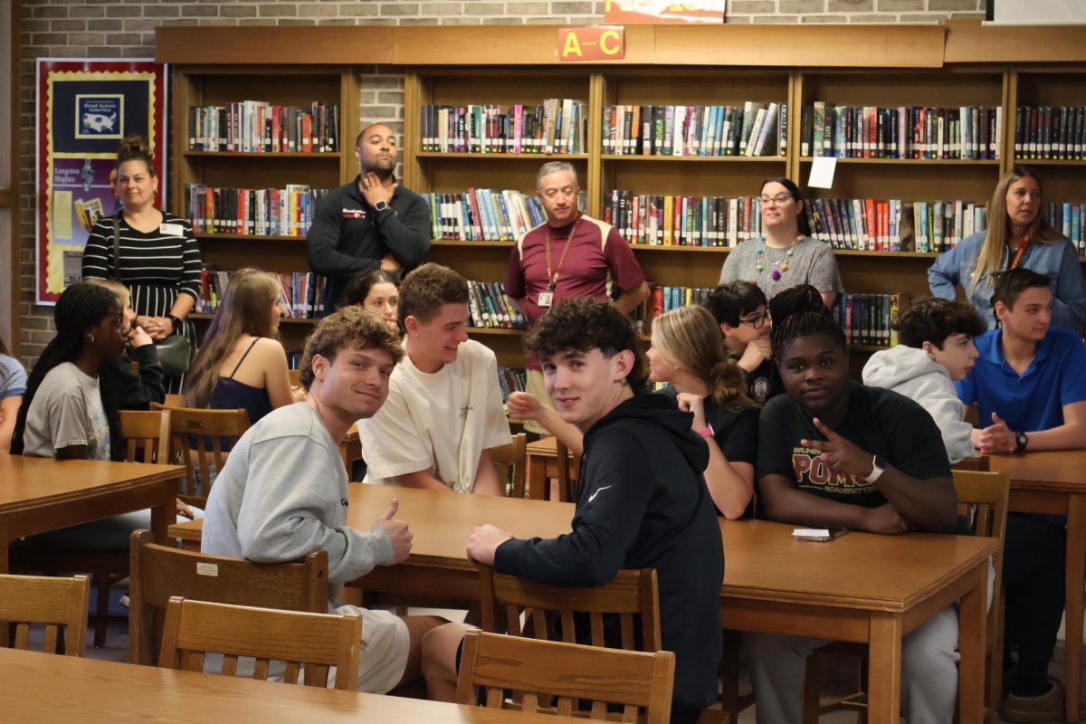 Students get around their peers and enjoy the award ceremony.