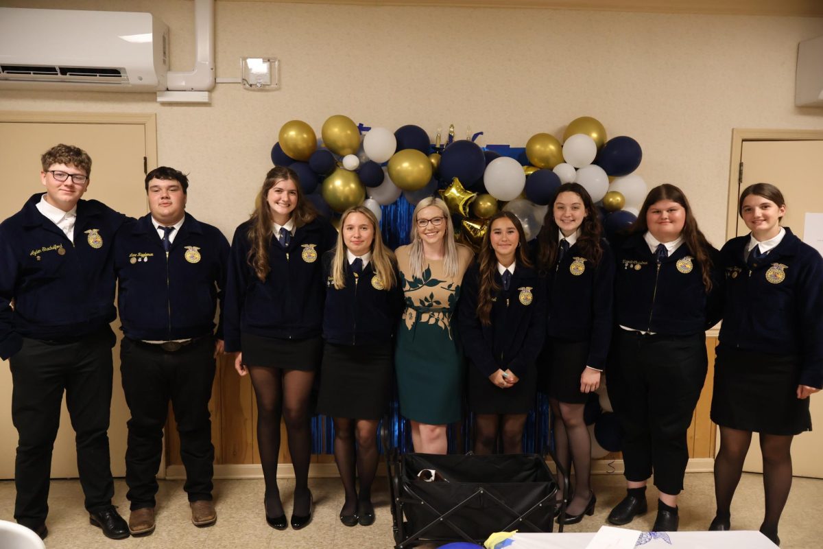 FFA group members posing for a picture. From left to right Ayden Shackelford, Lane Riggleman, Andie Welsh, Hannah Cook, Mrs. Stockman, Emma Pearrel, Atley Shafer, and Victoria Christman. 
