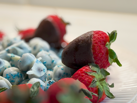Chocolate covered strawberries and blueberries.
