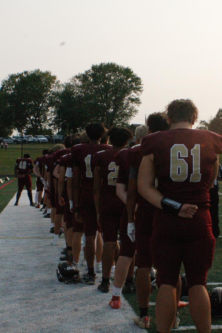 Brunswick Varsity Football players lined up on the sidelines during the National Anthem.
