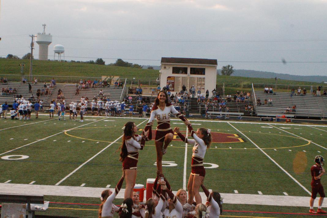 Brunswick Varsity Cheerleaders doing a stunt, holding up their flyer Khloe Lynch, senior.