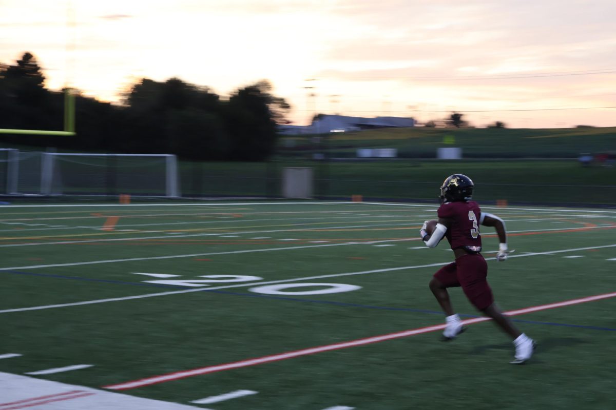 Barima Baffoe runs the ball past the 30-yard line in the first quarter of the game.