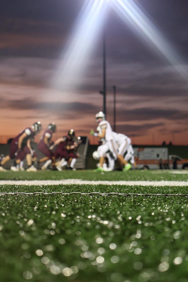 The football team was ready to start a new play as the sun sets.