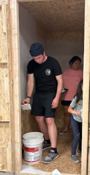David Hardt, Jenni Holdridge, and Millie Holdridge (L-R) painting the inside of the elevator that will be featured in the haunting experience. 