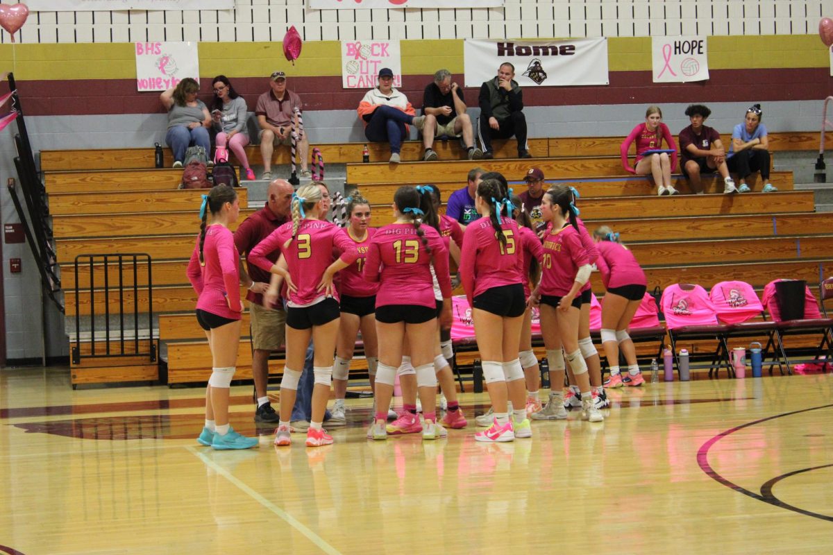 BHS Varsity Volleyball team huddles up before the start of their game.
