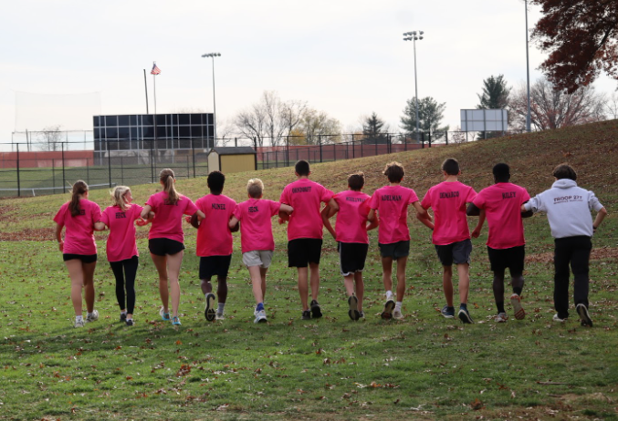 The cross country seniors ending their season as they skip away together.