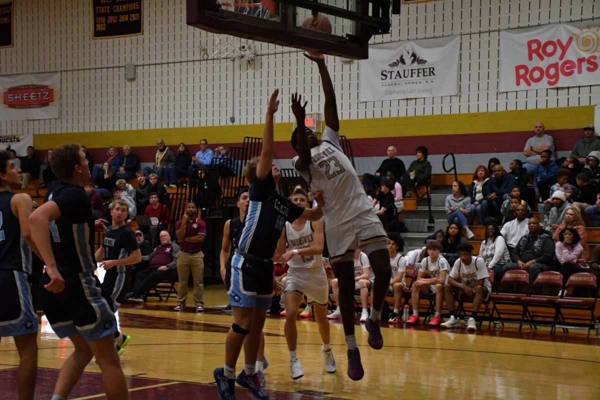 Mark Yongbi, '27, making a layup over Catoctin.

Photo taken by Lindsey Pearre