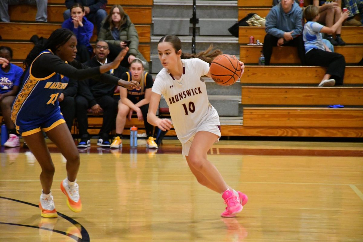 Emme Miller, '28, dribbling up court during the game.Photo taken by Lindsay Pearre
