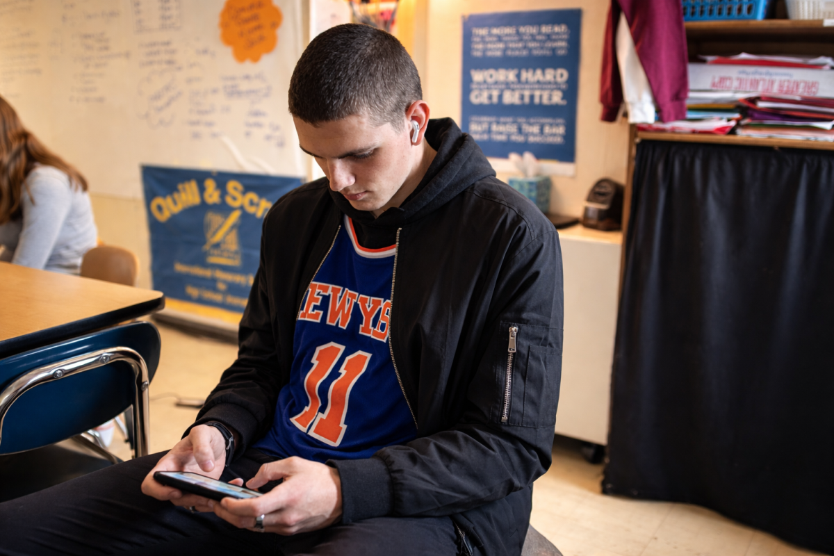 Student playing games on their phone in the middle of class.