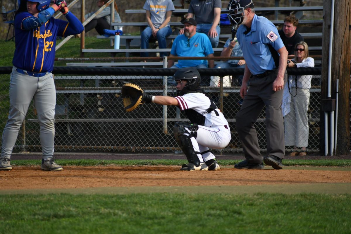 LJ Tobery behind the plate, makes a catch against Walkersville.