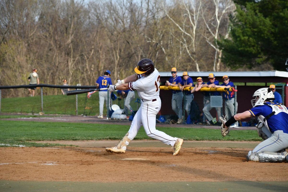 Carter Vinar, a junior, swings level and hits a foul ball. 