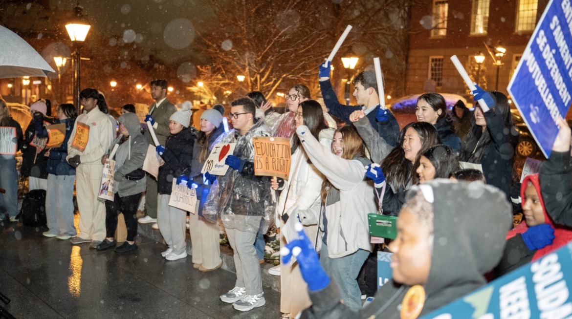 Students gathered on the podium at the Blueprint Day Rally holding up signs. Photo used with permission from Strong Schools Maryland Media.