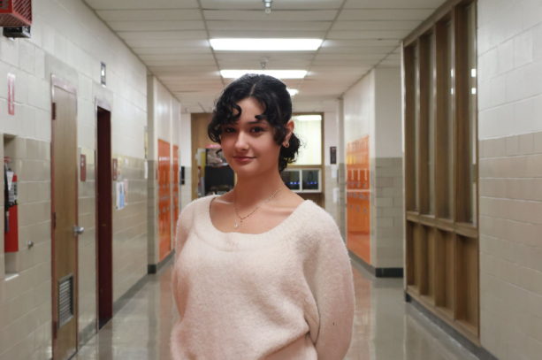 Isabella (Belle) Simmons presents herself in the Brunswick High hallway.
