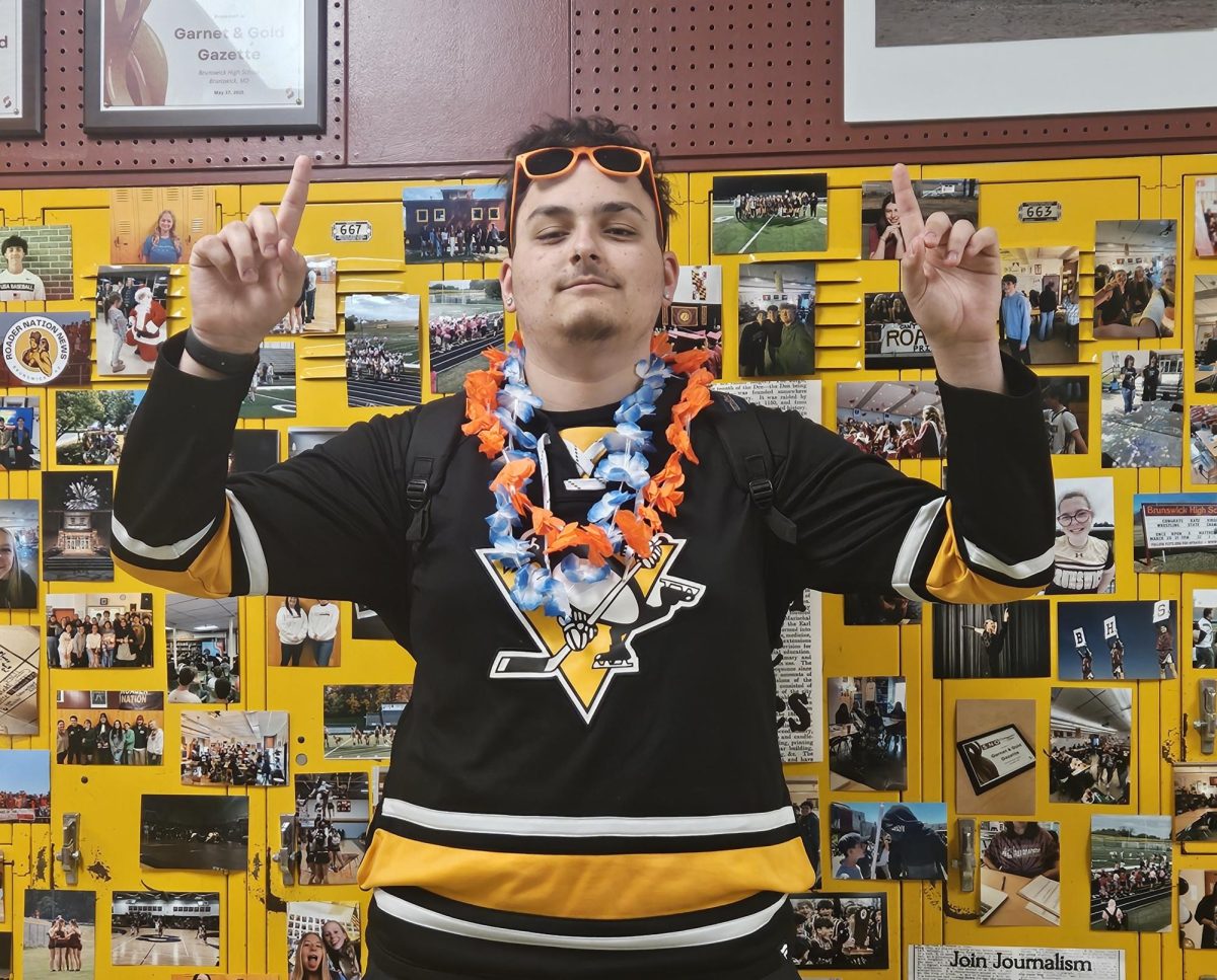 Gabriel Berkey standing infront of Mrs. Graziano's picture board outside her classroom.