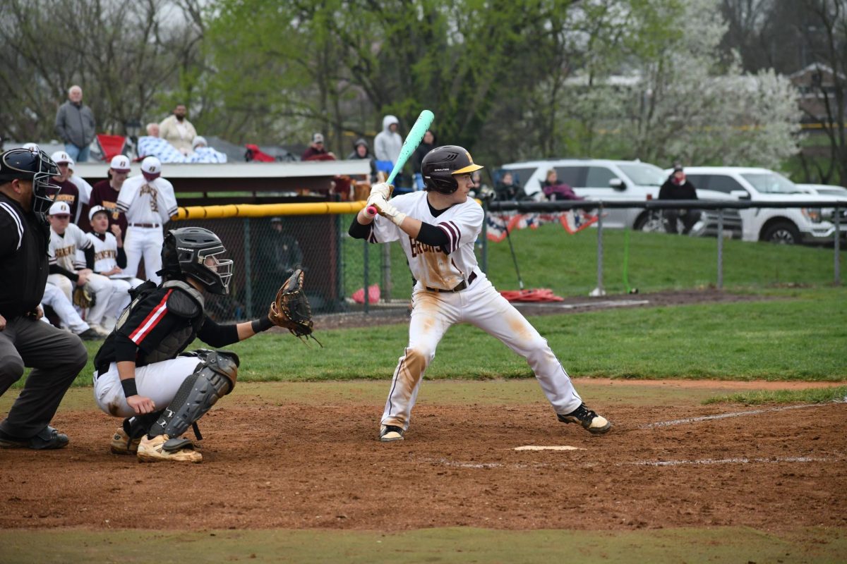 Catcher, LJ Tobery, junior, striding before swinging.  