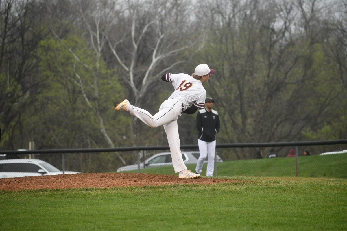 #19, Jared Rickets, throwing a fast pitch.
