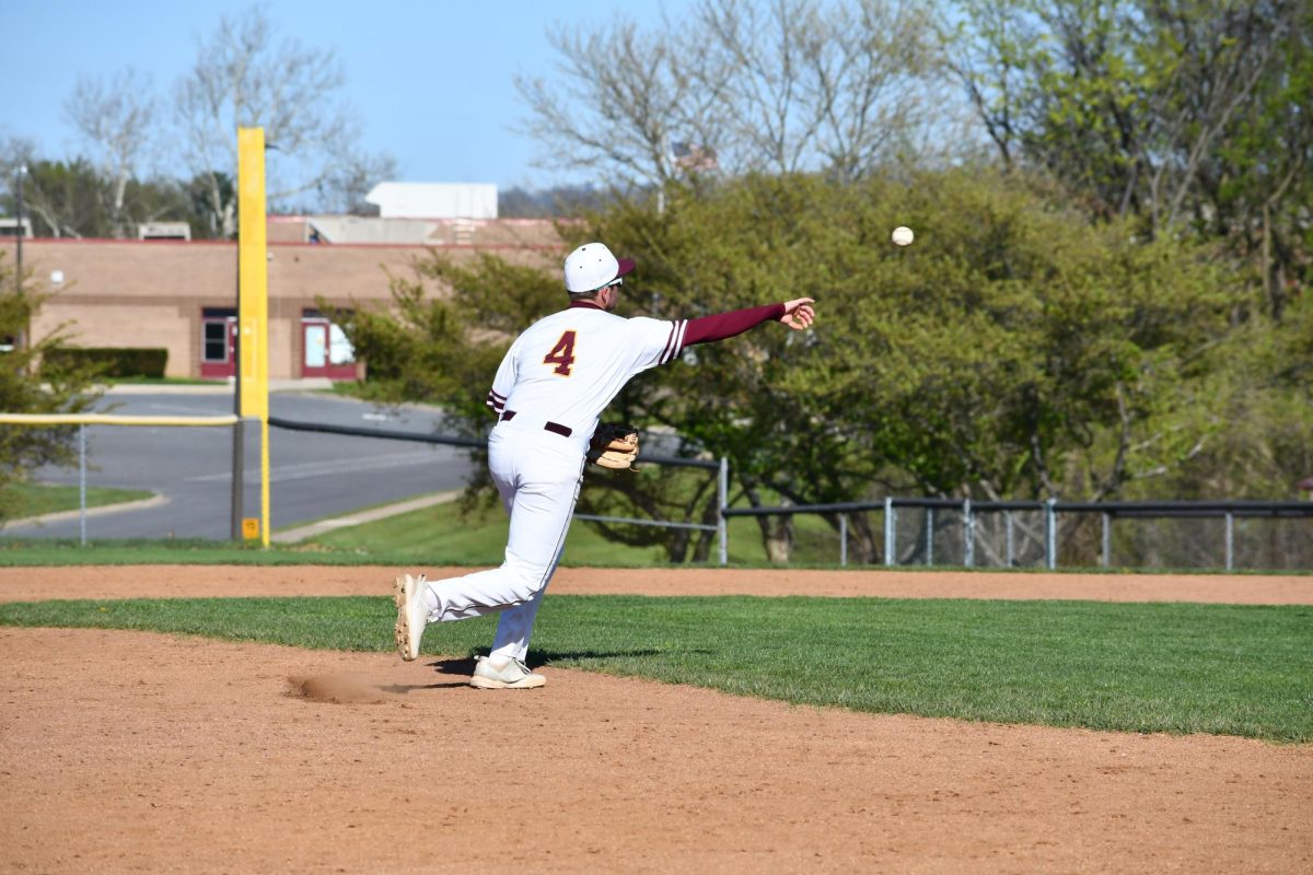 Pitcher, Zach Via, senior, picking off a runner at first base. 