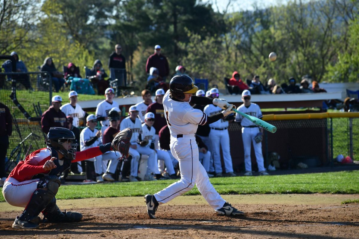 Catcher, LJ Tobery, junior, in the middle of his swing.