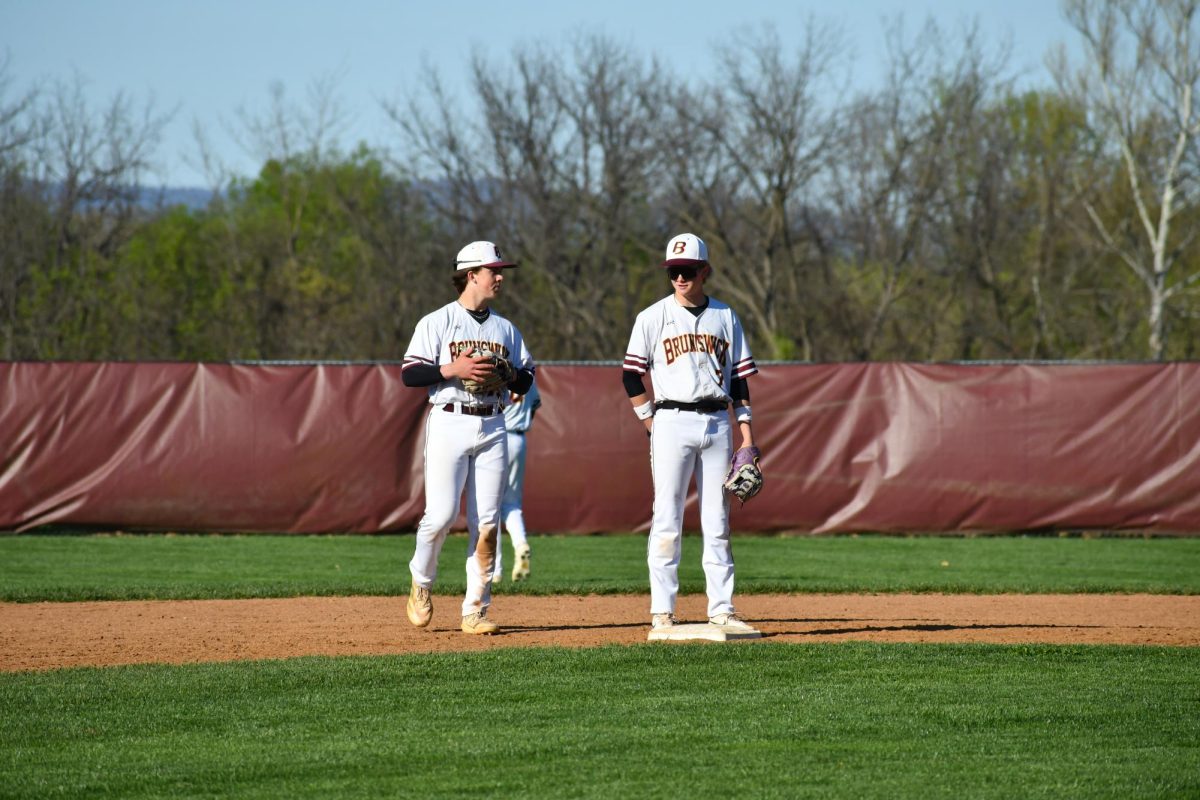 Shortstop, Carter Vinar, junior, and second baseman, Dillon Murphy, junior, standing on second base having a chat.  