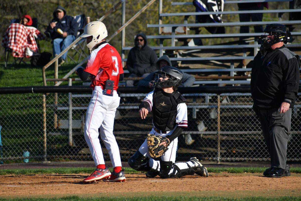 Catcher, LJ Tobery, junior, throws the ball back to the pitcher after catching it. 