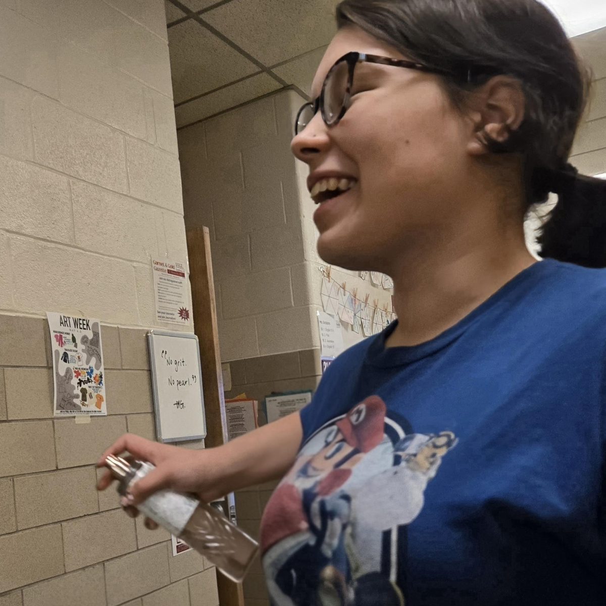 Emily WhiteHurst Gleefully spritzes her body spray.
